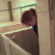 A woman is recorded taking a piss into a public floor toilet. She appears surprised when she sees the camera after finishing. Over a minute.